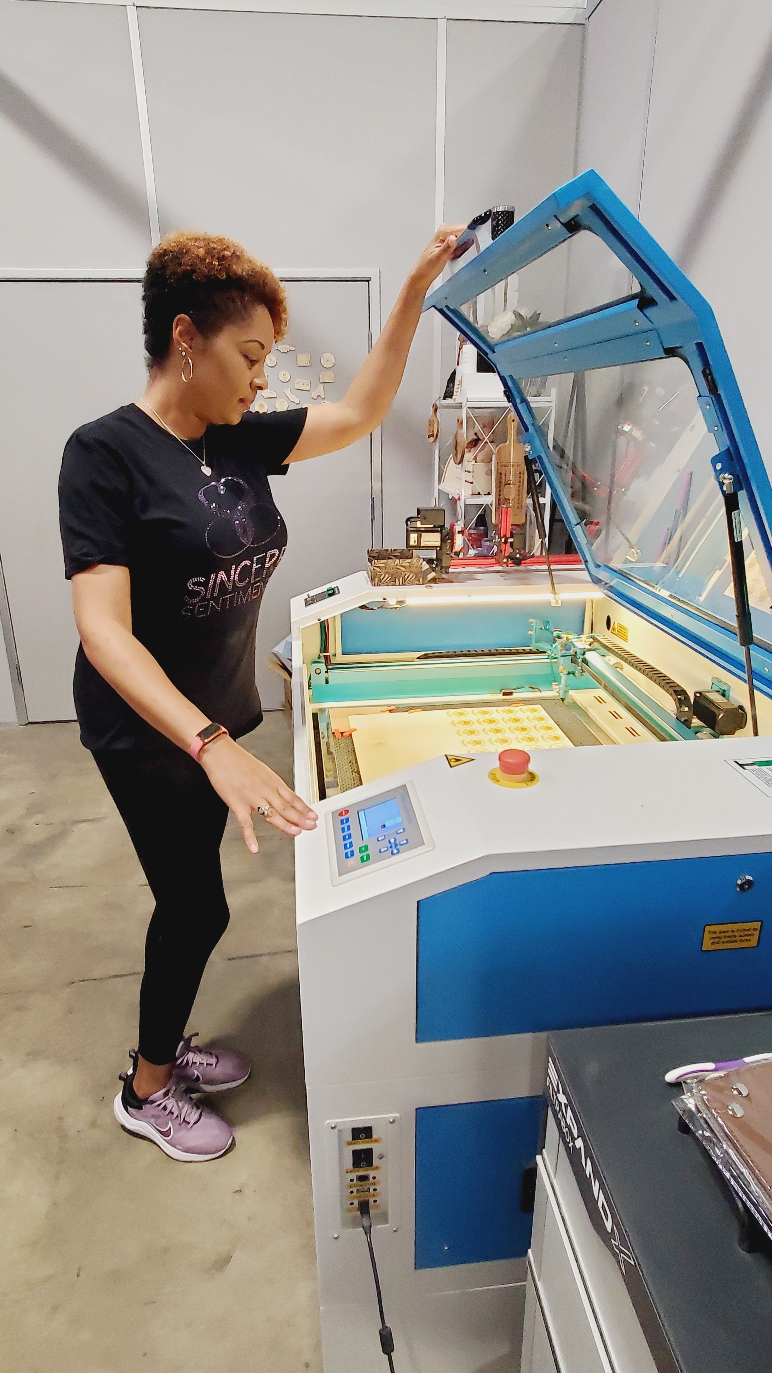 Owner of Sincere Sentiments working on laser machine