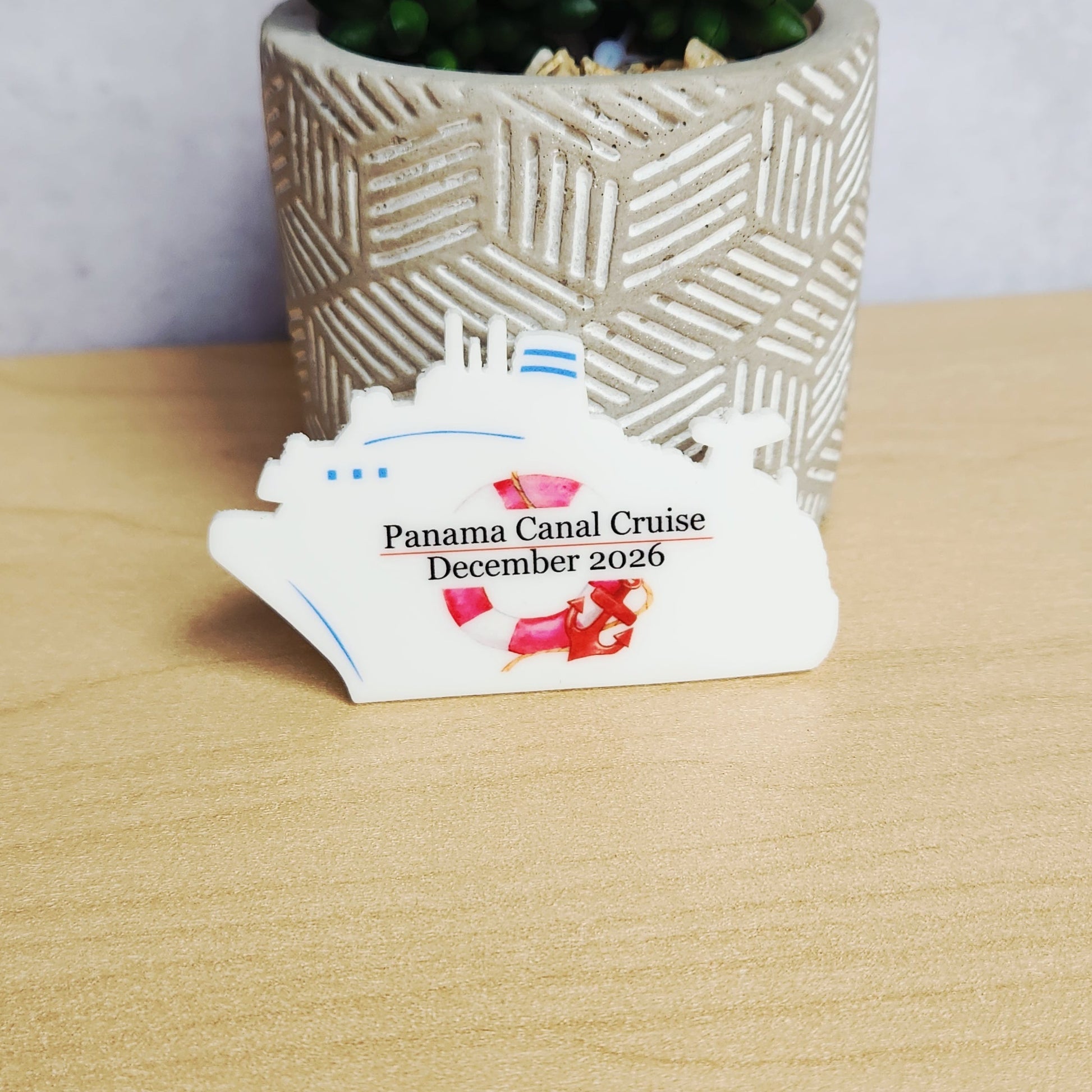 Personalized white cruise ship door magnet featuring a ship silhouette shape with “Panama Canal Cruise December 2026” printed in black text, accented with a red anchor and lifebuoy design.