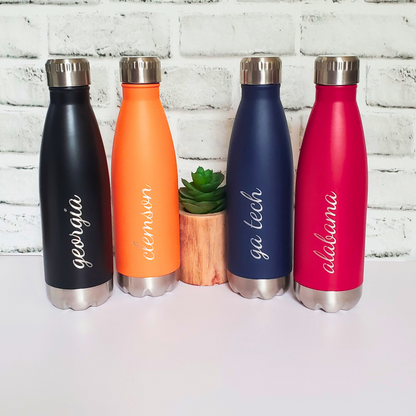 Personalized college water bottle 17oz insulated – custom school name game day gift.  The black bottle has Georgia engraved on it in script. The orange bottle has Clemson, the navy blue has GA tech, and the red has Alabama.