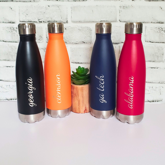 Personalized college water bottle 17oz insulated – custom school name game day gift.  The black bottle has Georgia engraved on it in script. The orange bottle has Clemson, the navy blue has GA tech, and the red has Alabama.