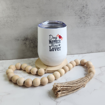 White Dog Mother Wine Lover stemless wine tumbler on wooden coaster, surrounded by a decorative wooden bead garland on a marble surface