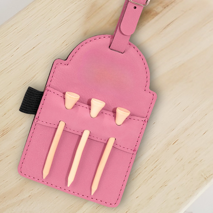 Back of a pink vegan leather golf bag tag holding three wooden golf tees.
