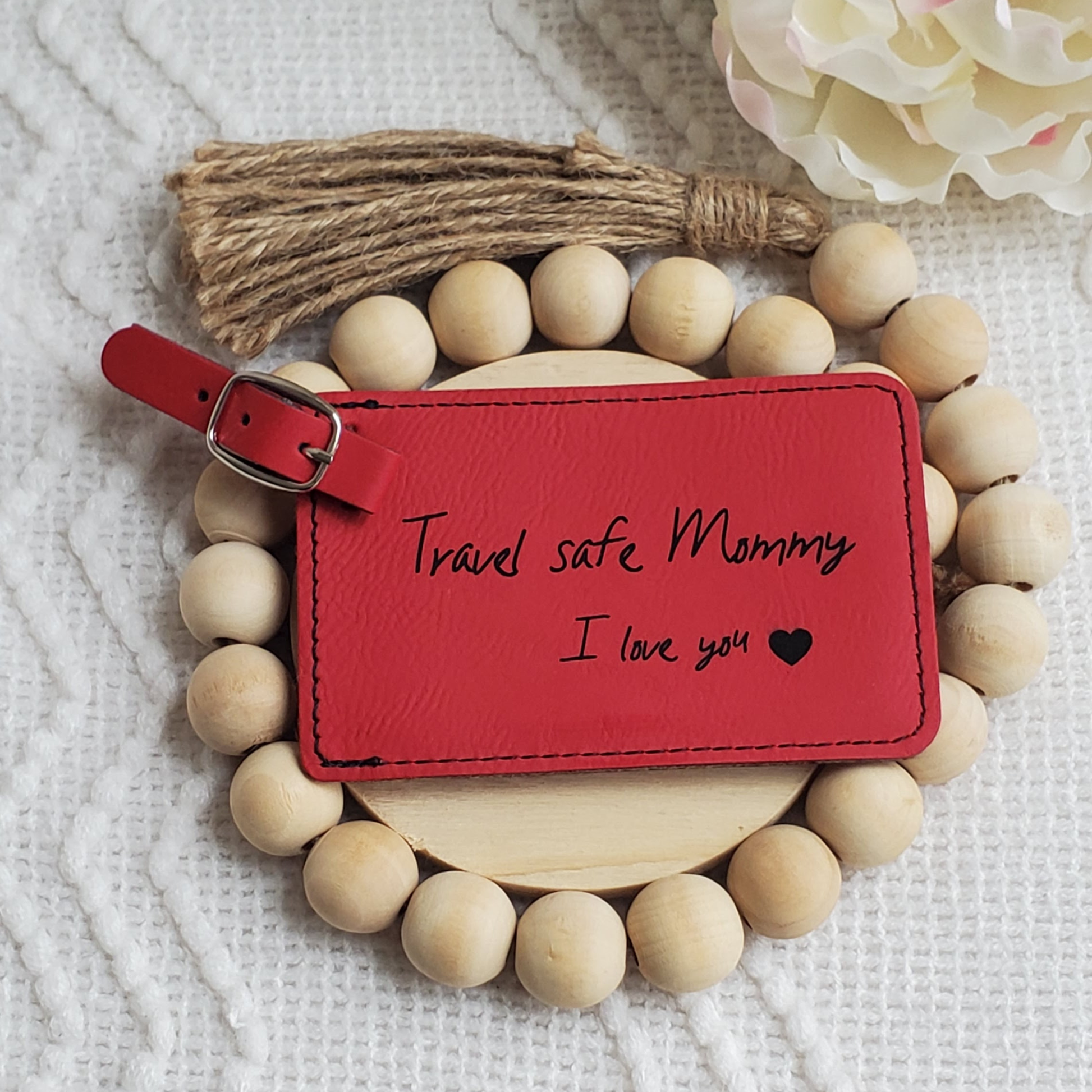 Red luggage Tag with the words Travel safe Mommy I love you and a heart engraved in black.