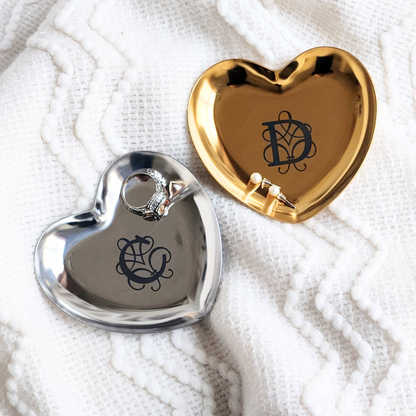 Heart-shaped silver and gold trinket dishes with monogram.