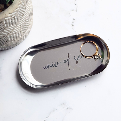 Silver jewelry tray with college name engraving. Jewelry tray holds a ring.