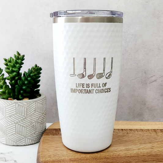 White dimpled golf tumbler with silver golf club engraving and the message Life is full of important choices.